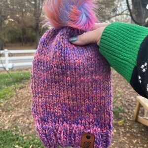 Hand knit beanie with a faux fur pom